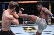 Francis Ngannou lands a high kick on Stipe Miocic.